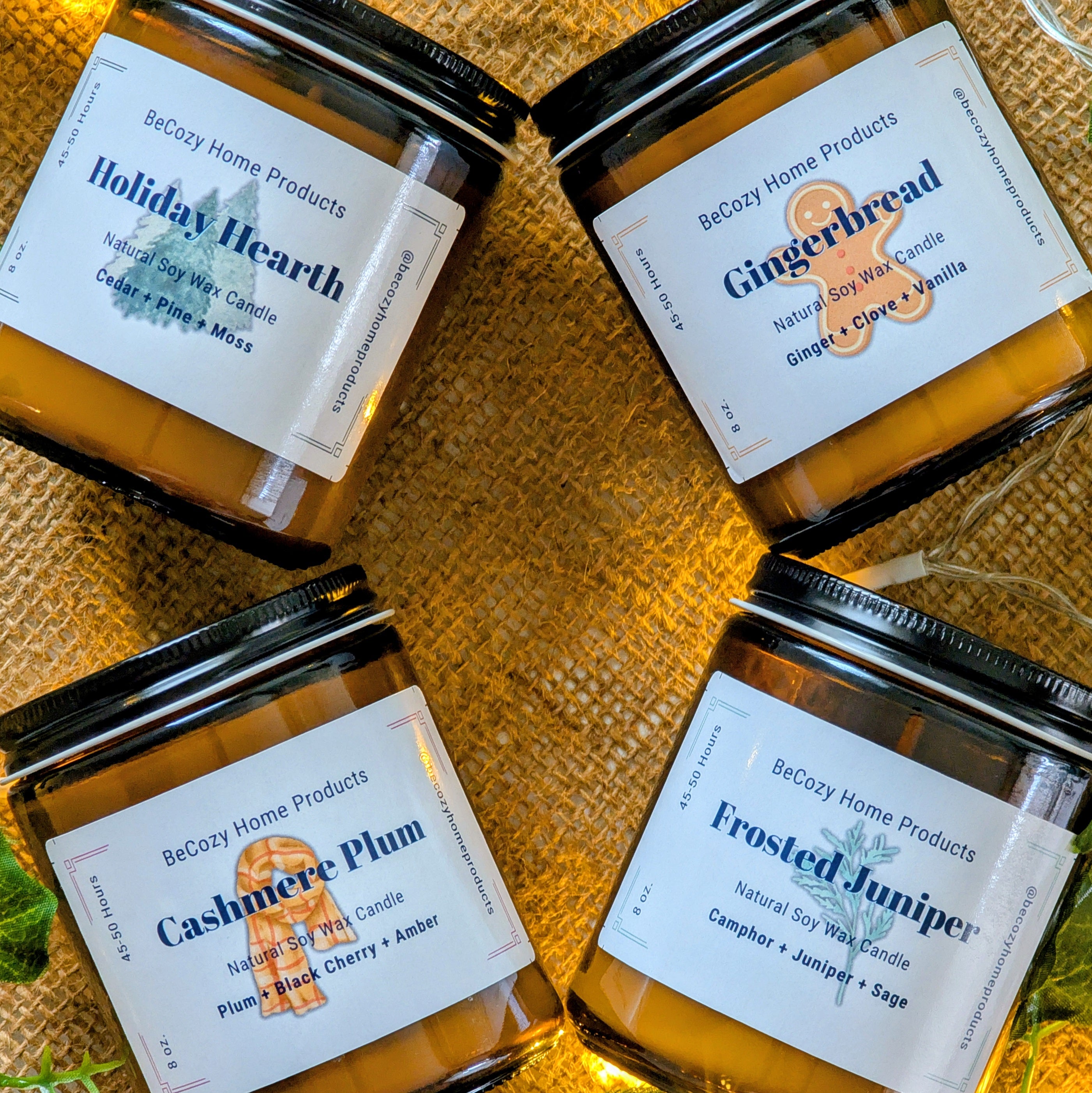 Four Holiday candles from BeCozy Home Products with labels on a textured surface.